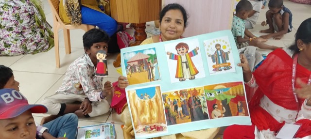 A teacher with children and a Bible story poster