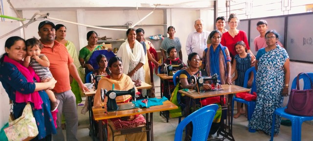 Women learning tailoring on sewing machines