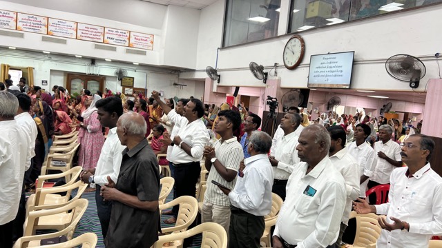 Worshippers standing in prayer during a service